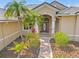 Inviting front entry featuring a brick path leading to an arched entryway with a decorative glass door at 6181 9Th Avenue Ne Cir, Bradenton, FL 34212