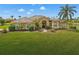 Beautiful single Gathering home with a well manicured green lawn, a brown roof, and a lake view at 6181 9Th Avenue Ne Cir, Bradenton, FL 34212