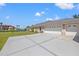 Spacious three-car garage with ample parking space, set against a backdrop of blue skies at 6181 9Th Avenue Ne Cir, Bradenton, FL 34212