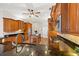 Kitchen featuring wood cabinets, black granite countertops, stainless steel appliances, and a center island at 6181 9Th Avenue Ne Cir, Bradenton, FL 34212