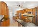 Well-equipped kitchen boasting rich wood cabinetry, granite countertops, and stainless steel appliances at 6181 9Th Avenue Ne Cir, Bradenton, FL 34212