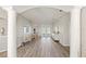 Spacious living room with wood floors, white columns, and french doors to a screened lanai at 6181 9Th Avenue Ne Cir, Bradenton, FL 34212