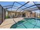 The screened-in pool area includes a large pool, spa, and brick-paved patio at 6181 9Th Avenue Ne Cir, Bradenton, FL 34212