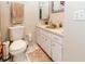 Clean bathroom featuring white cabinets, a toilet, and a mirror above the sink at 6188 Chesham Dr # 5, New Port Richey, FL 34653
