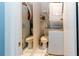 Functional bathroom with a stacked washer and dryer unit and adjacent toilet at 6188 Chesham Dr # 5, New Port Richey, FL 34653