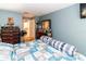 Bedroom with blue walls, two dressers, and a washer dryer visible in an adjacent room at 6188 Chesham Dr # 5, New Port Richey, FL 34653