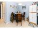 Cozy dining area featuring a round wooden table with chairs, adjacent to the living space at 6188 Chesham Dr # 5, New Port Richey, FL 34653