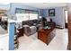 Cozy living room featuring plush furniture, tile flooring, and a view of the front yard through a window at 6188 Chesham Dr # 5, New Port Richey, FL 34653