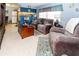 Comfortable living room with plush sofas, tile flooring, and open layout to the kitchen area at 6188 Chesham Dr # 5, New Port Richey, FL 34653