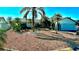 Single-story home with a well-maintained yard and mature palm trees in a sunny setting at 6526 Senegal Palm Way, Apollo Beach, FL 33572