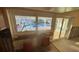 Partially renovated kitchen featuring a view of the pool and patio through large windows at 6526 Senegal Palm Way, Apollo Beach, FL 33572