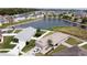 Aerial view shows a waterfront home with an attached two-car garage and a white fence at 6632 Laxey Ct, Zephyrhills, FL 33541