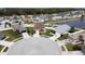 Stunning aerial view of a community with lush landscaping and a serene lake, offering a picturesque setting at 6632 Laxey Ct, Zephyrhills, FL 33541
