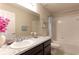 The well-lit bathroom features tile walls, a granite counter, and modern fixtures at 6632 Laxey Ct, Zephyrhills, FL 33541