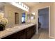 Spacious bathroom with double vanity, walk-in shower, and a view into the Primary bedroom at 6632 Laxey Ct, Zephyrhills, FL 33541