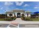 The community clubhouse is surrounded by colorful landscaping, offering a welcoming gathering place at 6632 Laxey Ct, Zephyrhills, FL 33541