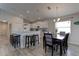 Open dining area with bar stool seating, modern chandelier, and access to the kitchen at 6632 Laxey Ct, Zephyrhills, FL 33541