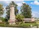 Stonebridge community entrance with stone pillars, landscaped gardens, and clear signage at 6632 Laxey Ct, Zephyrhills, FL 33541