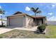 Charming single-story home with a two-car garage, lush landscaping, and a well-maintained lawn at 6632 Laxey Ct, Zephyrhills, FL 33541