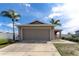 Inviting single-Gathering home featuring a two-car garage, a concrete driveway, and tasteful landscaping at 6632 Laxey Ct, Zephyrhills, FL 33541