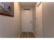 Hallway with wood-look floors, a white front door, and a sign reading 'Bless This House' at 6632 Laxey Ct, Zephyrhills, FL 33541