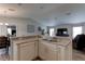 Bright kitchen features stainless sink, white cabinets, and granite countertops overlooking the dining and living room at 6632 Laxey Ct, Zephyrhills, FL 33541
