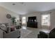 Comfortable living room with a large television, decorative accents, and natural light at 6632 Laxey Ct, Zephyrhills, FL 33541