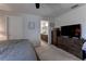 Comfortable main bedroom with ceiling fan, dresser, and entry to ensuite bathroom with granite vanity at 6632 Laxey Ct, Zephyrhills, FL 33541