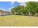 Lush backyard with a mix of grass and trees for a private outdoor space at 904 Woodland Dr, Seffner, FL 33584