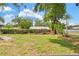 Large, grassy backyard featuring mature trees and a wood fence at 904 Woodland Dr, Seffner, FL 33584