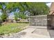 Backyard featuring a screened-in lanai, concrete patio, and partial fence at 904 Woodland Dr, Seffner, FL 33584
