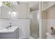Clean white tiled bathroom features a shower and vanity at 904 Woodland Dr, Seffner, FL 33584