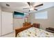 Comfortable bedroom with tiled floor, mini split AC, and a ceiling fan at 904 Woodland Dr, Seffner, FL 33584