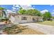 Charming single-story brick home with a long driveway and well-manicured front yard at 904 Woodland Dr, Seffner, FL 33584