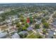 An aerial view of the property showing the home's location with a pool nestled in a mature and lushly landscaped neighborhood at 9044 Lynwood Dr, Seminole, FL 33772