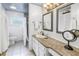 Bright bathroom with a large vanity, granite countertop, updated fixtures, and a shower with tile surround at 9044 Lynwood Dr, Seminole, FL 33772