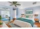 Bright bedroom featuring hardwood floors, ceiling fan, and a comfortable, well-lit space at 9044 Lynwood Dr, Seminole, FL 33772