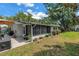 Home exterior displaying the backyard, patio, sunroom and lush landscaping at 9044 Lynwood Dr, Seminole, FL 33772