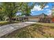 Charming single-story home with a spacious driveway, attached two car garage, and mature landscaping at 9044 Lynwood Dr, Seminole, FL 33772