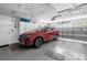 Spacious garage with an updated door and a modern red SUV at 9044 Lynwood Dr, Seminole, FL 33772