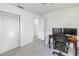 Modern home office space with sliding closet doors, neutral walls, and desk with dual monitors at 9044 Lynwood Dr, Seminole, FL 33772