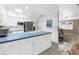 Spacious kitchen with white cabinets, an island cooktop, and stainless steel appliances at 9044 Lynwood Dr, Seminole, FL 33772