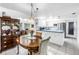 Well-lit eat-in kitchen with white cabinetry, tile flooring, and stainless steel appliances at 9044 Lynwood Dr, Seminole, FL 33772
