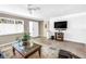 Bright living room with tile floors, white brick accent wall, and a welcoming atmosphere at 9044 Lynwood Dr, Seminole, FL 33772