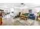 Inviting living room featuring tile floors, an open layout, and views into the dining area at 9044 Lynwood Dr, Seminole, FL 33772