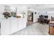 Open concept living space with tiled floor, built-in cabinets, and a view into the office area at 9044 Lynwood Dr, Seminole, FL 33772