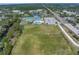 Aerial view of a recreation center with large grass sports fields, basketball courts, pool, buildings, and a parking lot at 9044 Lynwood Dr, Seminole, FL 33772