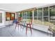 Bright sunroom featuring a table with chairs and multiple windows overlooking the green backyard at 9044 Lynwood Dr, Seminole, FL 33772