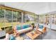 Comfortable sunroom with stylish furniture and tranquil backyard views at 9044 Lynwood Dr, Seminole, FL 33772