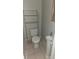 Cozy bathroom featuring a toilet, sink, and shelving for toiletries or linens at 1015 23Rd W Ave, Bradenton, FL 34205